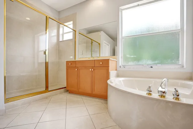 a large spacious bathroom with a tub and shower