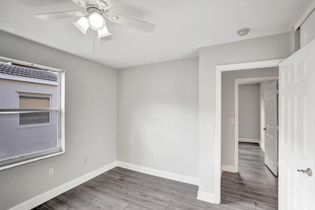 a view of an empty room and wooden floor