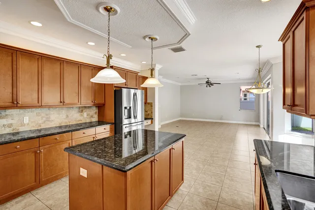 a kitchen with stainless steel appliances granite countertop a sink a counter space and cabinets