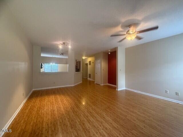 6020 Winterpointe Lane, Unit 103 Raleigh, NC 27606 - Photo 15 of 17 a view of an empty room with window and wooden floor