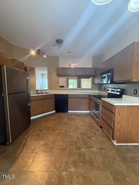 6020 Winterpointe Lane, Unit 103 Raleigh, NC 27606 - Photo 5 of 17 a large kitchen with cabinets and stainless steel appliances