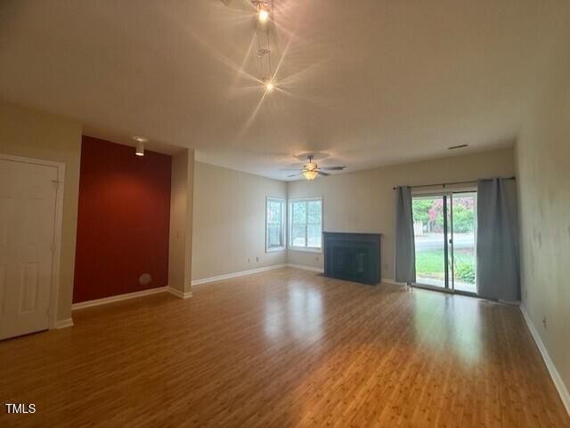 6020 Winterpointe Lane, Unit 103 Raleigh, NC 27606 - Photo 8 of 17 an empty room with wooden floor and windows