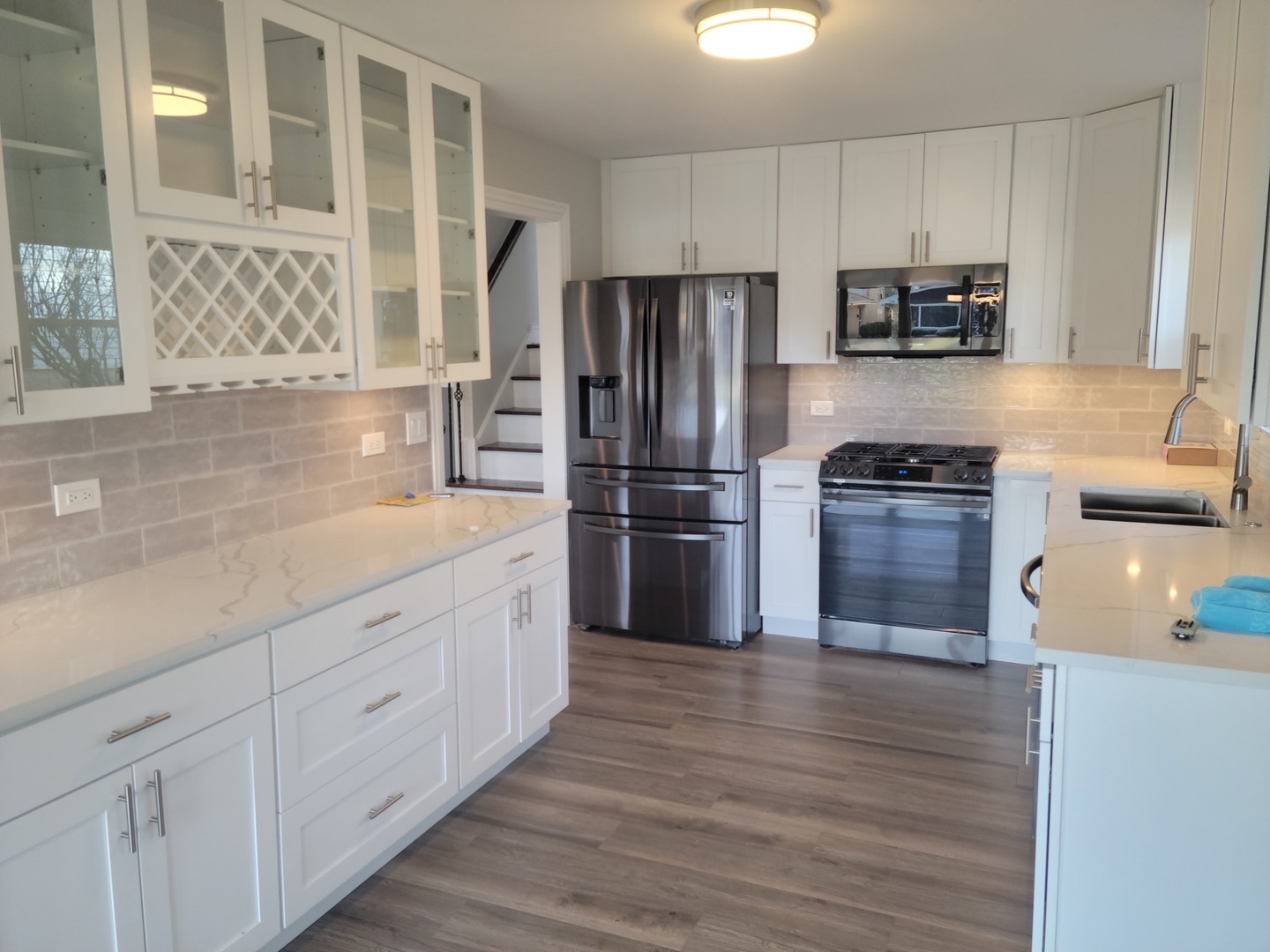 908 Long Road Glenview, IL 60025 - Photo 3 of 15 a kitchen with granite countertop white cabinets and stainless steel appliances