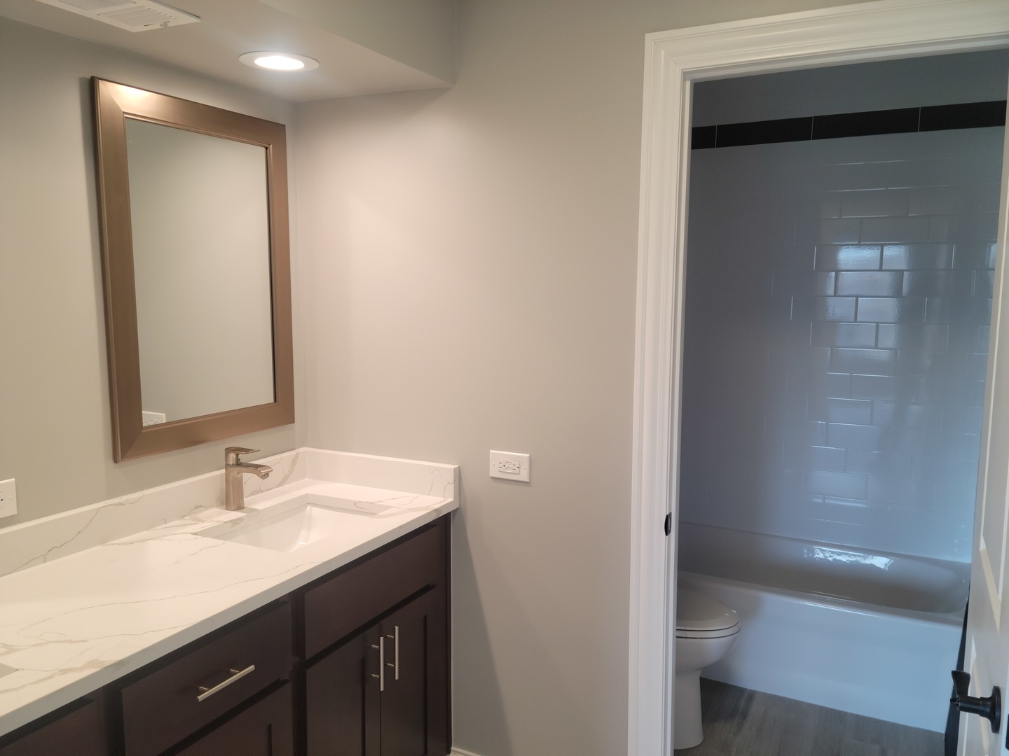 908 Long Road Glenview, IL 60025 - Photo 6 of 15 a bathroom with a sink a light fixture and a mirror