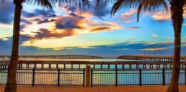 an aerial view of a house with a yard and lake view