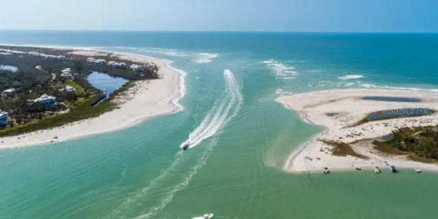 an aerial view of a house with a garden and lake view