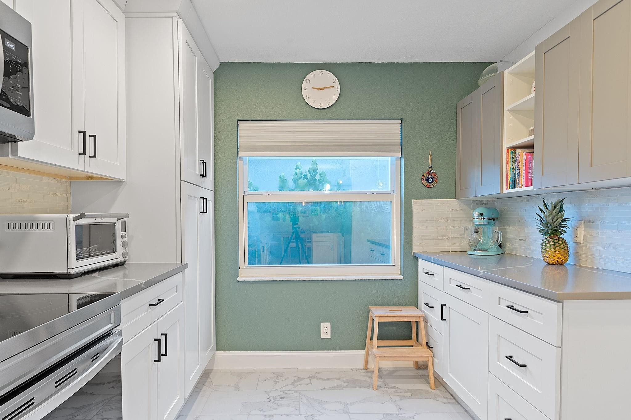 22848 Southwest 54th Way Boca Raton, FL 33433 - Photo 14 of 44 a kitchen with white cabinets and window