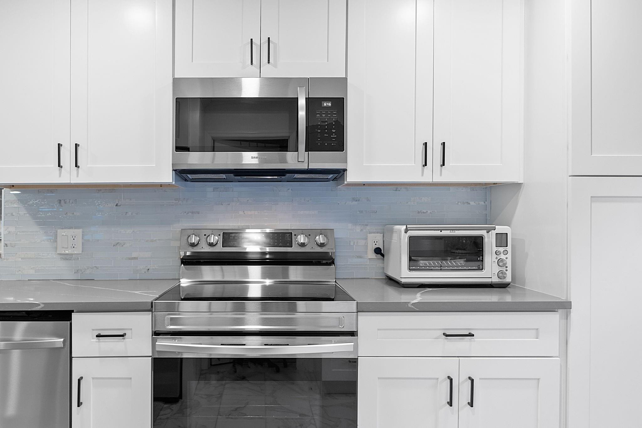 22848 Southwest 54th Way Boca Raton, FL 33433 - Photo 15 of 44 a kitchen with stainless steel appliances granite countertop a stove microwave and oven