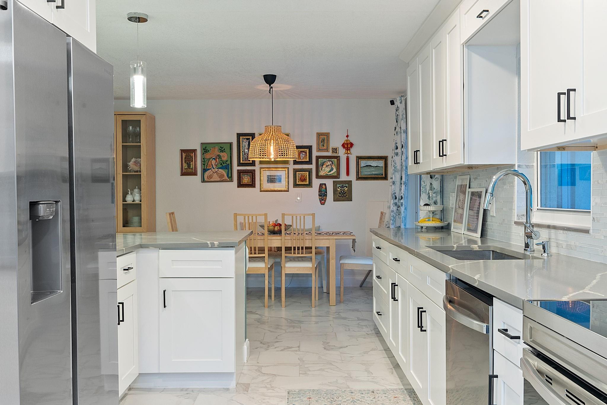 22848 Southwest 54th Way Boca Raton, FL 33433 - Photo 16 of 44 a kitchen with counter top space cabinets and stainless steel appliances
