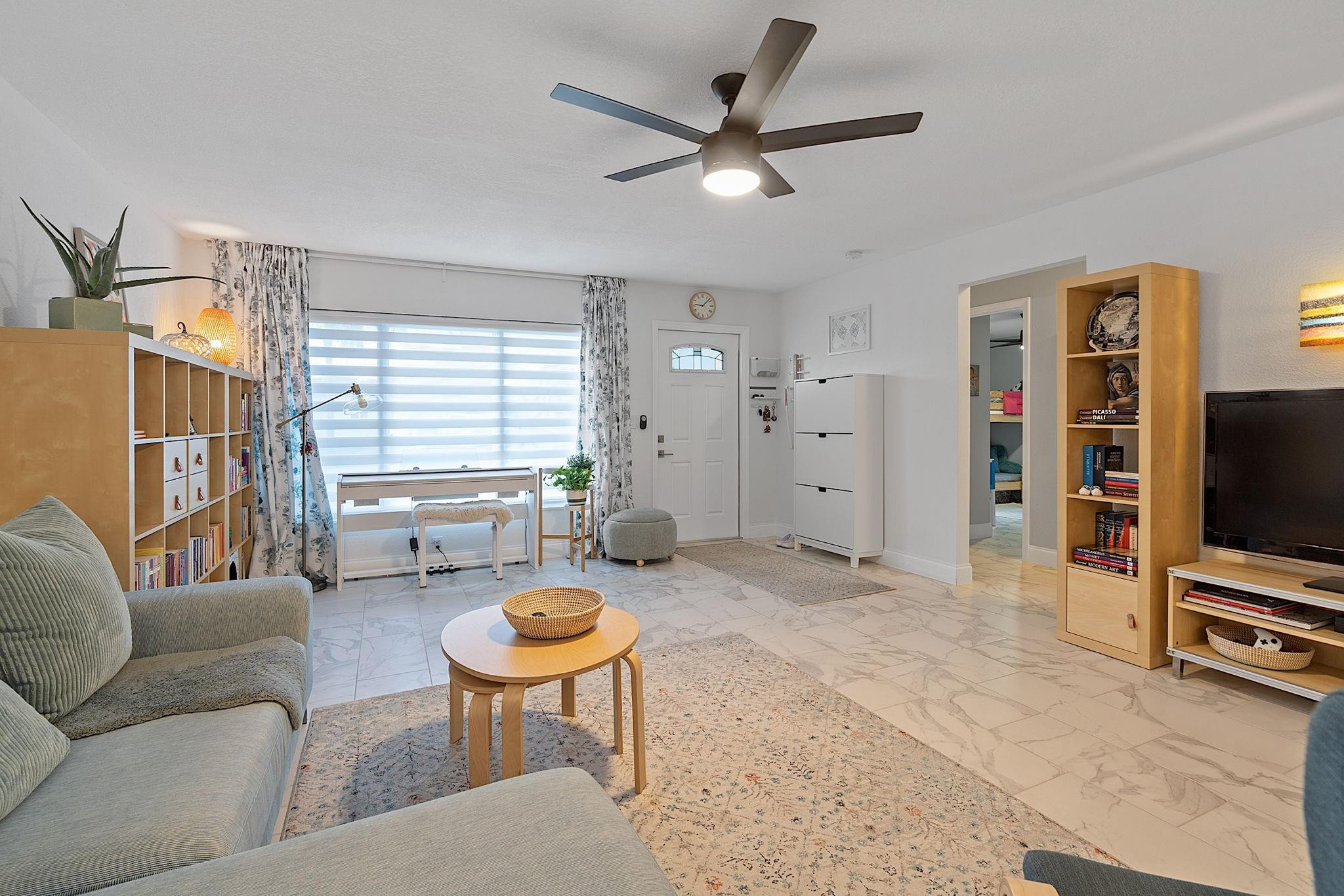 22848 Southwest 54th Way Boca Raton, FL 33433 - Photo 20 of 44 a living room with furniture a window and a flat screen tv