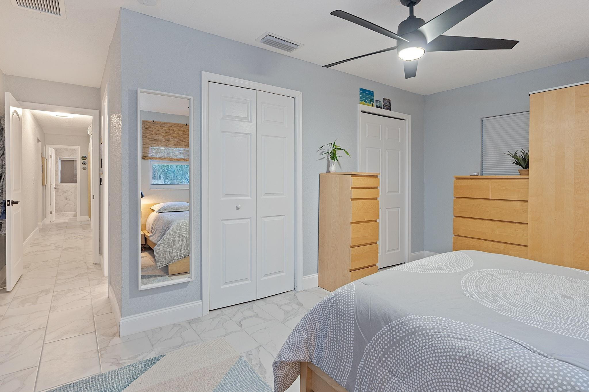 22848 Southwest 54th Way Boca Raton, FL 33433 - Photo 31 of 44 a bedroom with a bed and a walk in closet