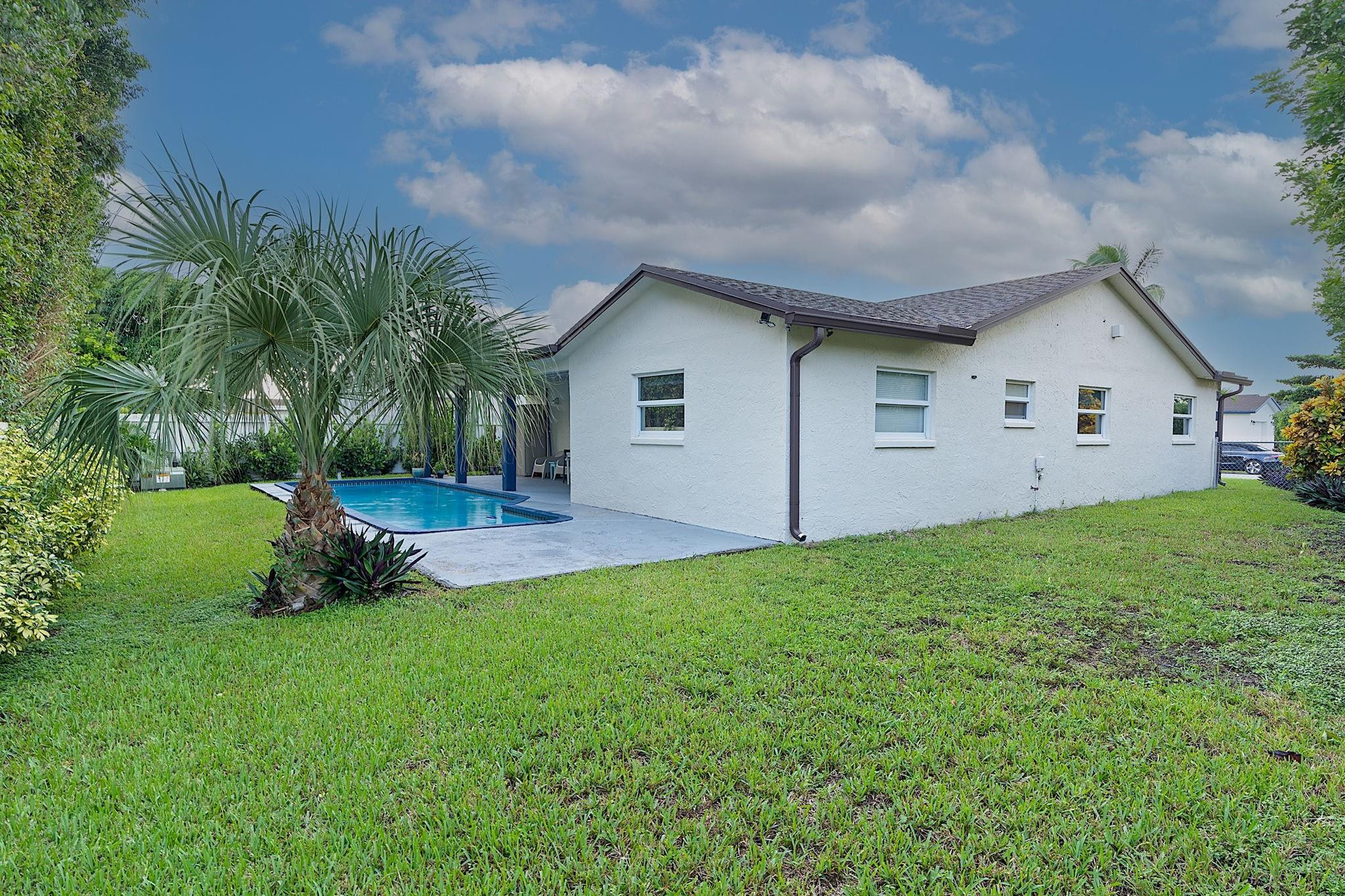22848 Southwest 54th Way Boca Raton, FL 33433 - Photo 39 of 44 a front view of house with yard and green space