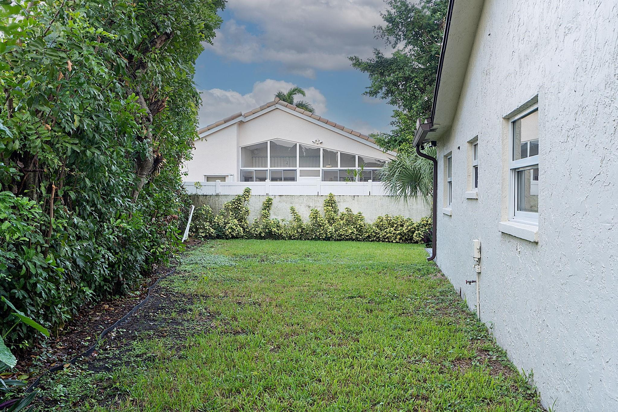 22848 Southwest 54th Way Boca Raton, FL 33433 - Photo 41 of 44 a front view of a house with a yard