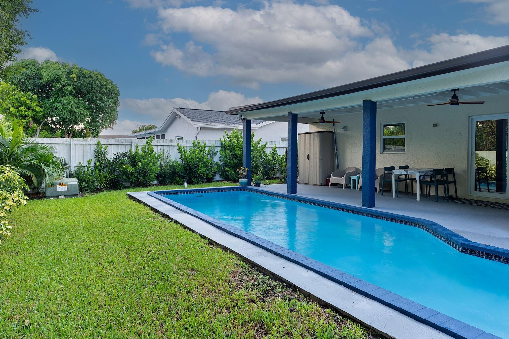 22848 Southwest 54th Way Boca Raton, FL 33433 - Photo 42 of 44 a view of swimming pool with lawn chairs and plants