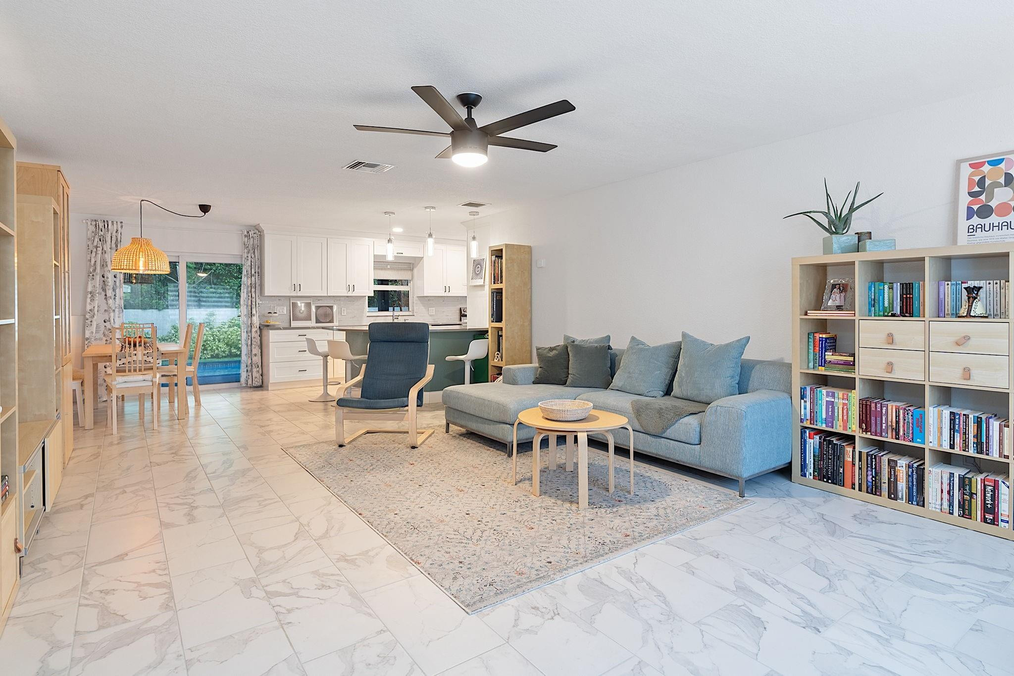 22848 Southwest 54th Way Boca Raton, FL 33433 - Photo 5 of 44 a living room with furniture and a book shelf