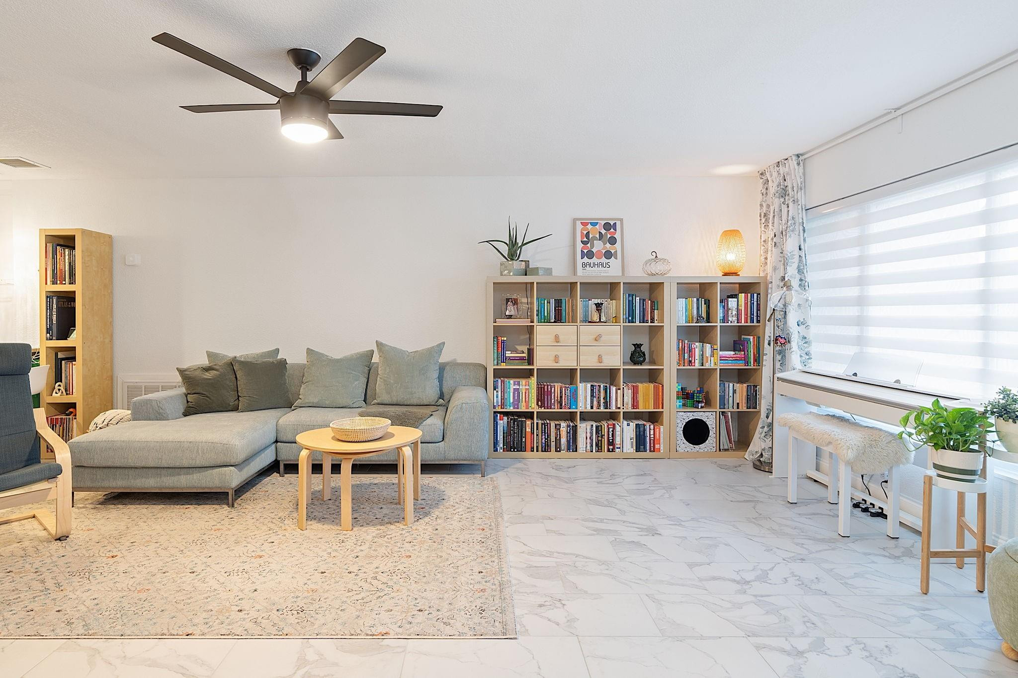 22848 Southwest 54th Way Boca Raton, FL 33433 - Photo 6 of 44 a living room with furniture and a book shelf
