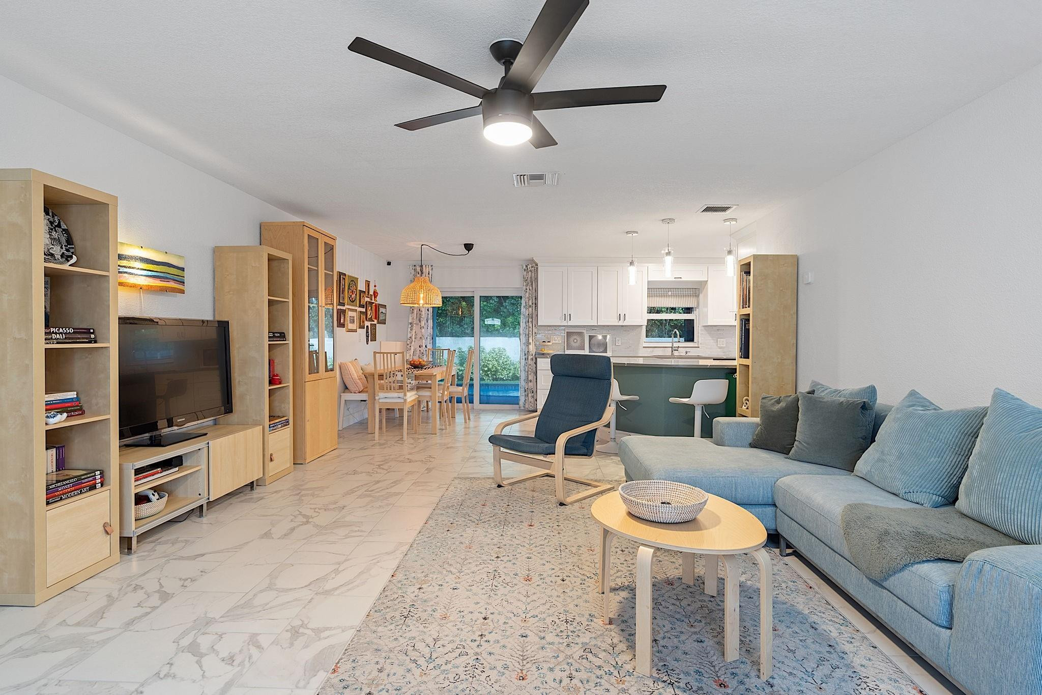 22848 Southwest 54th Way Boca Raton, FL 33433 - Photo 7 of 44 a living room with furniture and a flat screen tv