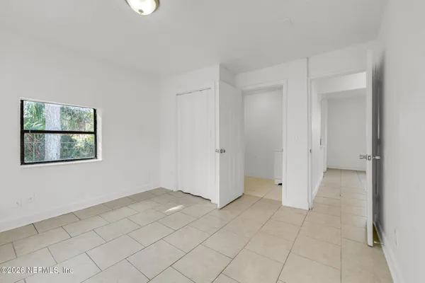 a bathroom with a toilet a sink a mirror and vanity