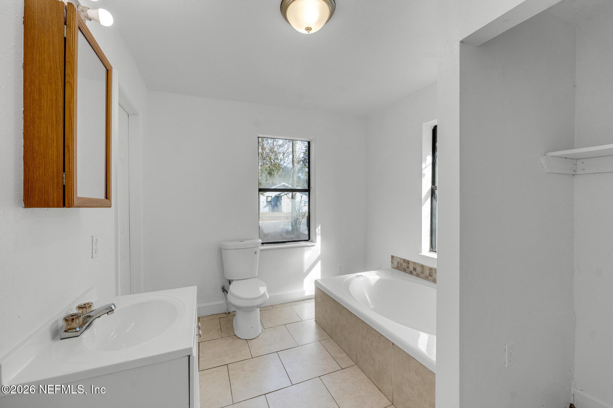 1830 West 27th Street Jacksonville, FL 32209 - Photo 17 of 21 a bathroom with a toilet sink and mirror