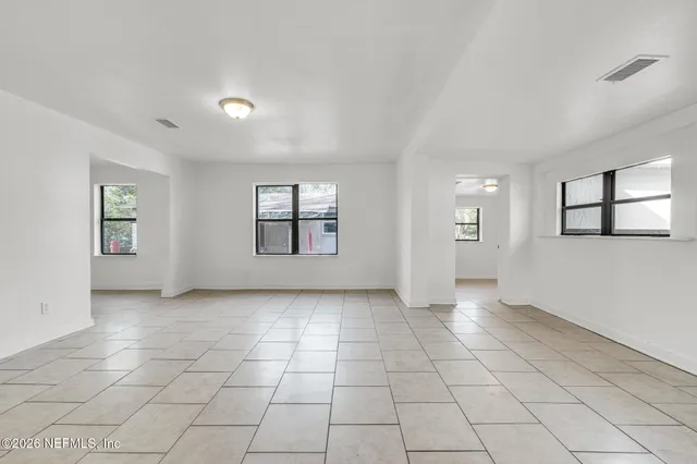a view of a backyard with a garden and trees