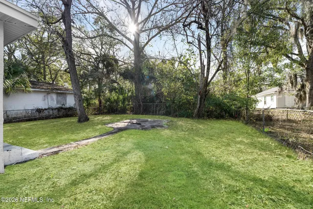 a view of a house with a yard and tree s