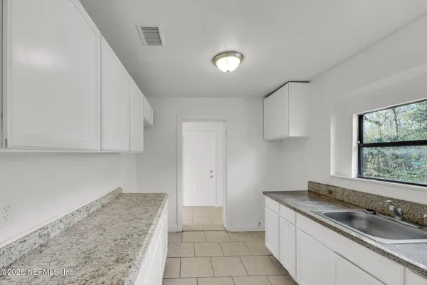 a kitchen that has a sink and a stove