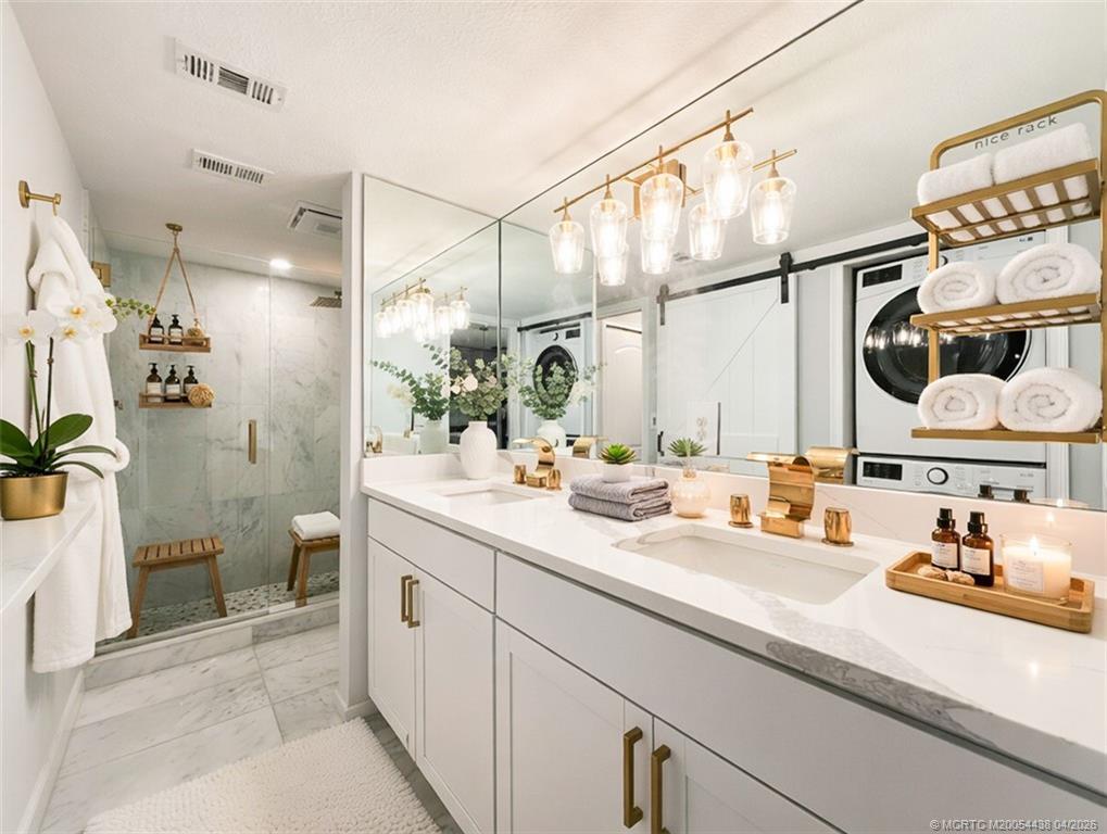 800 Northwest Fork Road, Unit 107 Stuart, FL 34994 - Photo 5 of 21 a bathroom with a sink and mirror with toilet