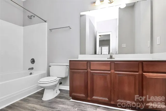 a bathroom with a shower curtain and toilet