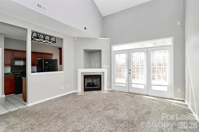a view of a livingroom with an entryway and a fireplace
