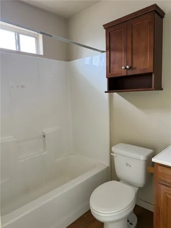 a bathroom with a toilet a sink and bathtub