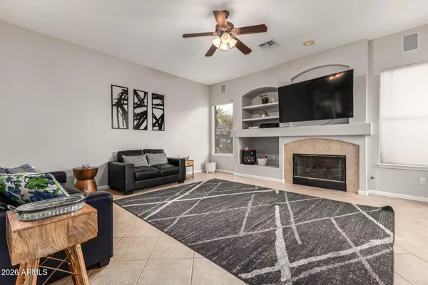 a living room with furniture a flat screen tv and a fireplace