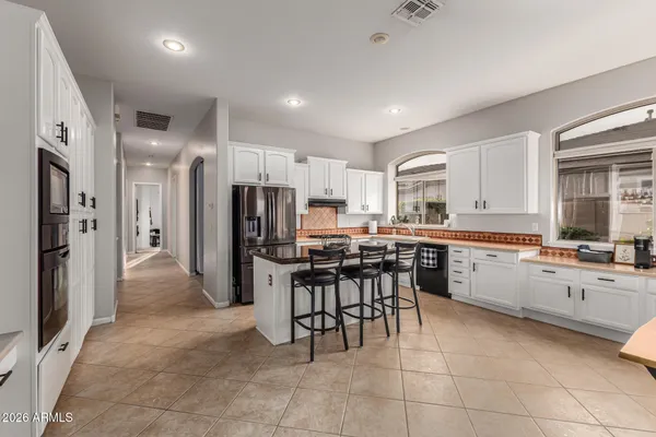 a kitchen with stainless steel appliances a refrigerator sink and cabinets
