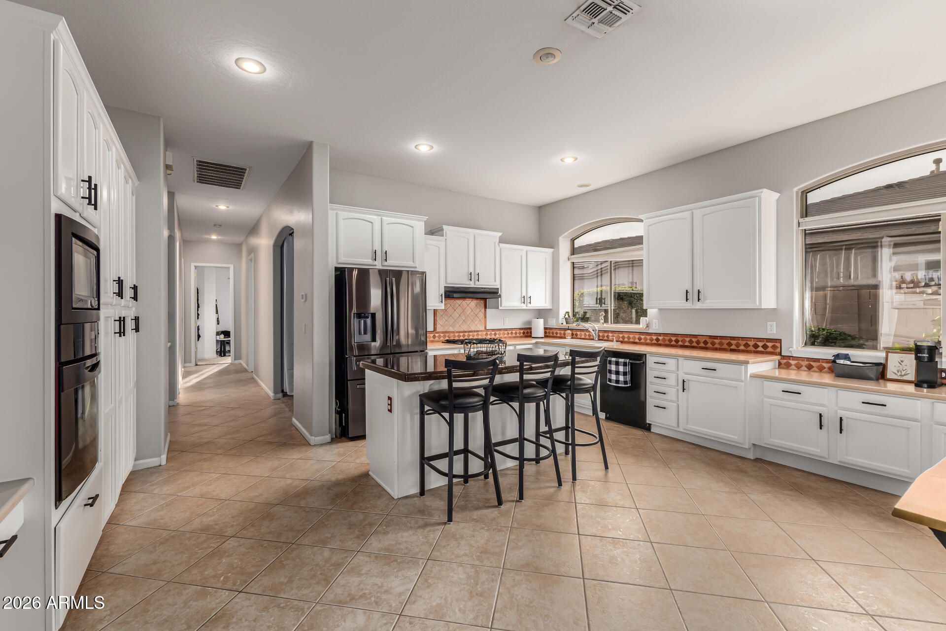 13318 West Coronado Road Goodyear, AZ 85395 - Photo 17 of 48 a kitchen with stainless steel appliances a refrigerator sink and cabinets