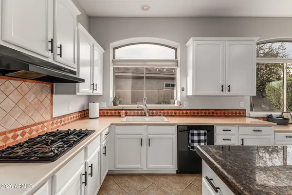 a kitchen with stainless steel appliances granite countertop a stove and a sink