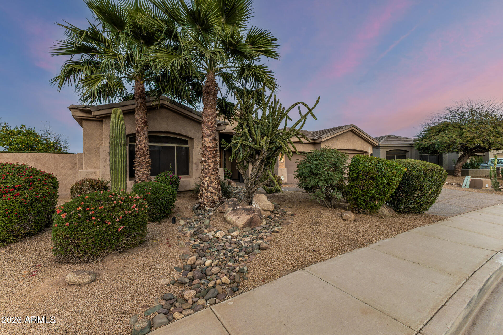 13318 West Coronado Road Goodyear, AZ 85395 - Photo 2 of 48 a front view of a house with a yard and potted plants