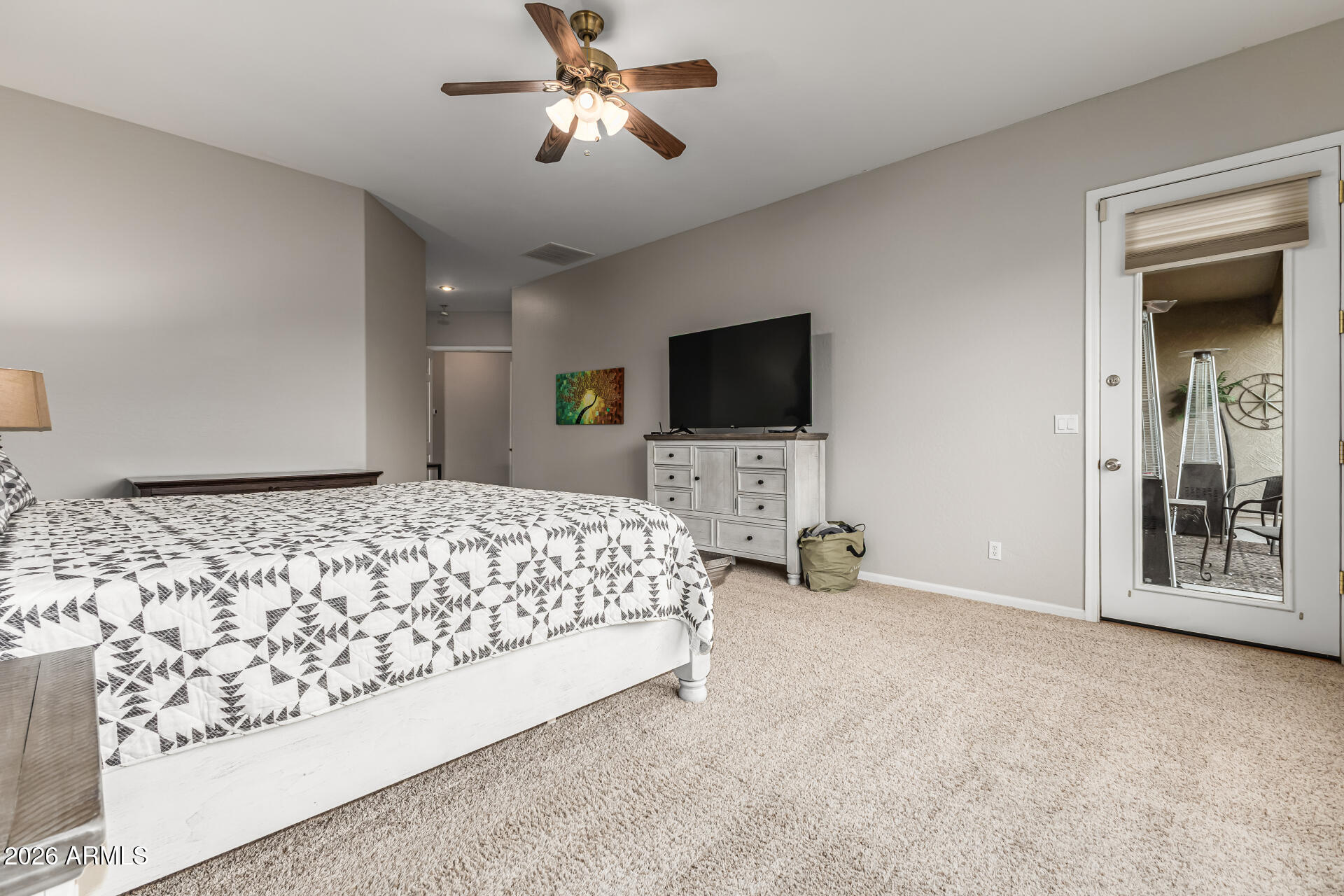 13318 West Coronado Road Goodyear, AZ 85395 - Photo 22 of 48 a bedroom with a bed and a flat screen tv