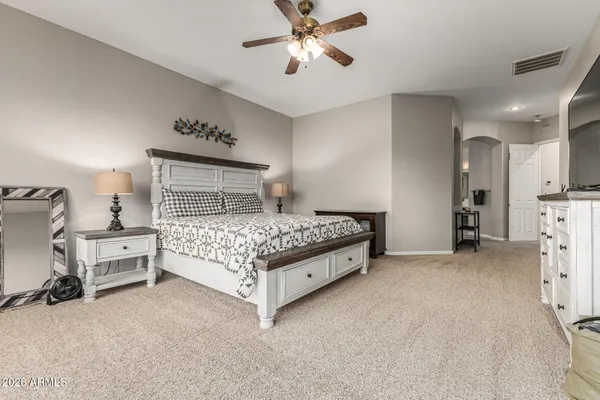 a bedroom with a bed and a chandelier