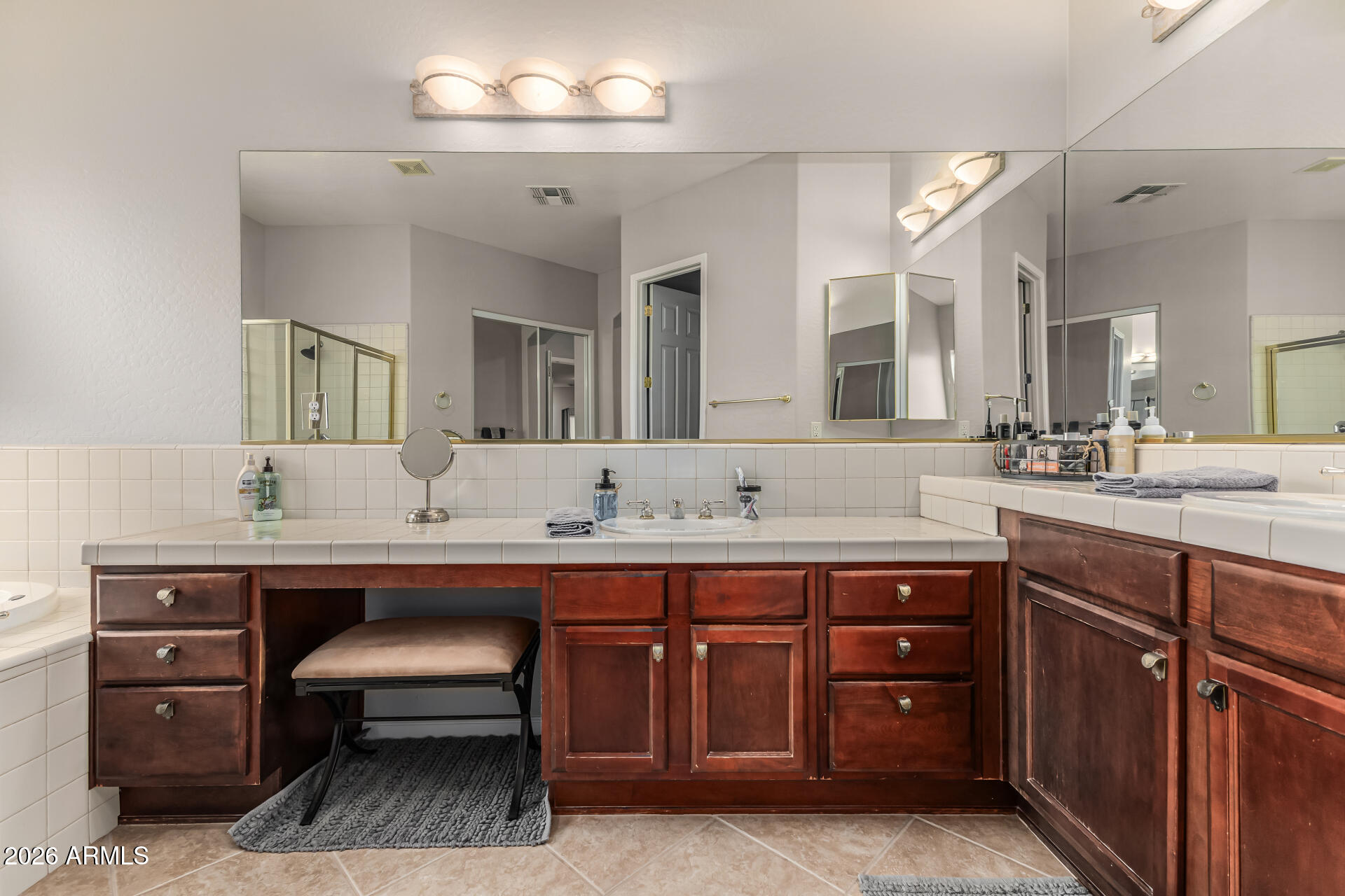 13318 West Coronado Road Goodyear, AZ 85395 - Photo 24 of 48 a spacious bathroom with a double vanity sink double and a mirror