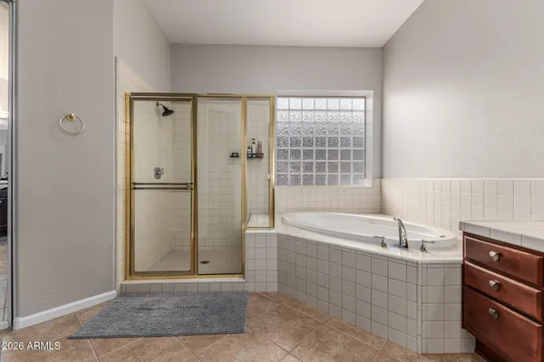 a bathroom with a bathtub and a shower