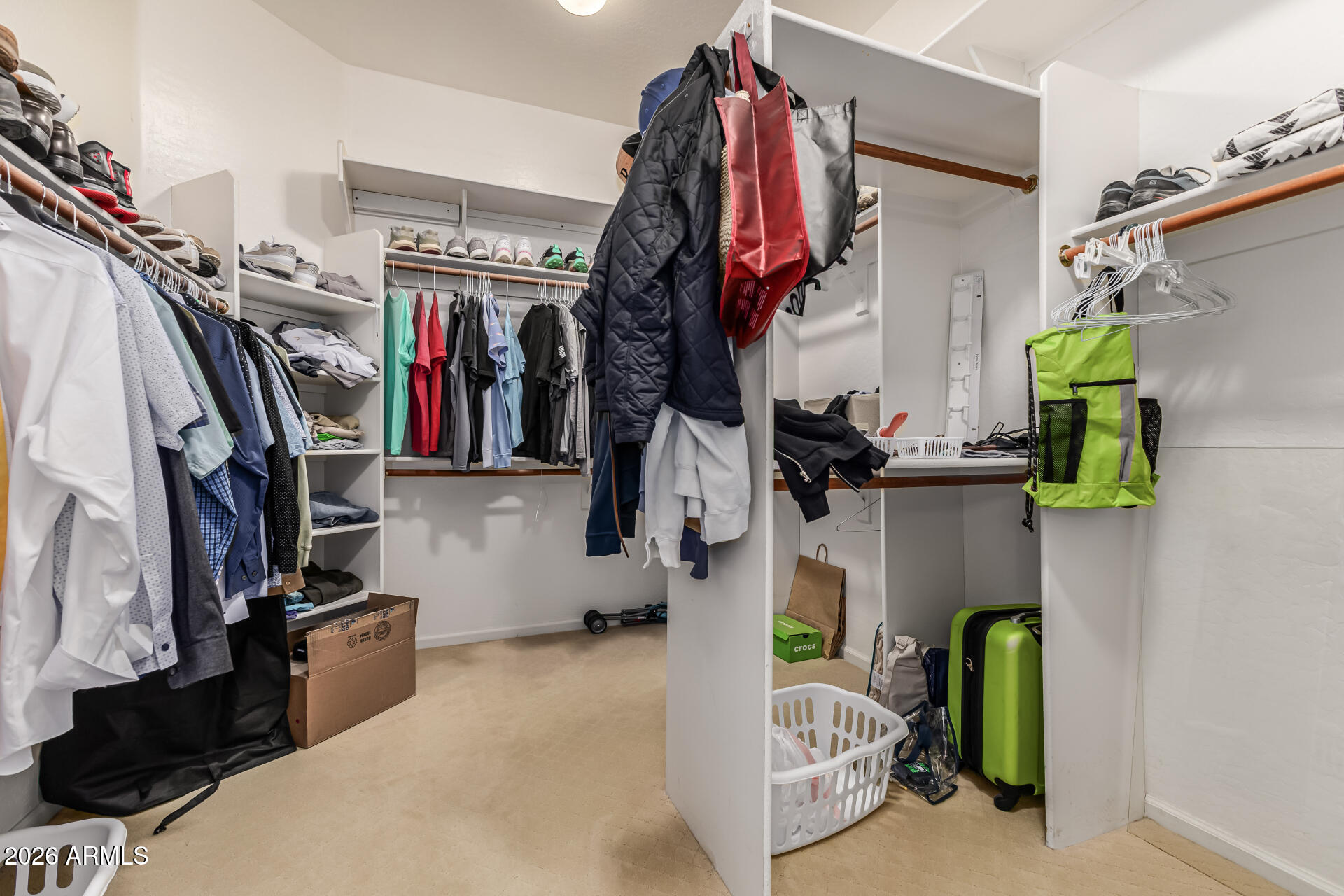 13318 West Coronado Road Goodyear, AZ 85395 - Photo 26 of 48 a view of walk in closet with clothes and shoes