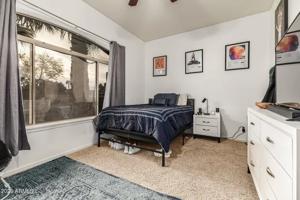 a bedroom with a bed and a window