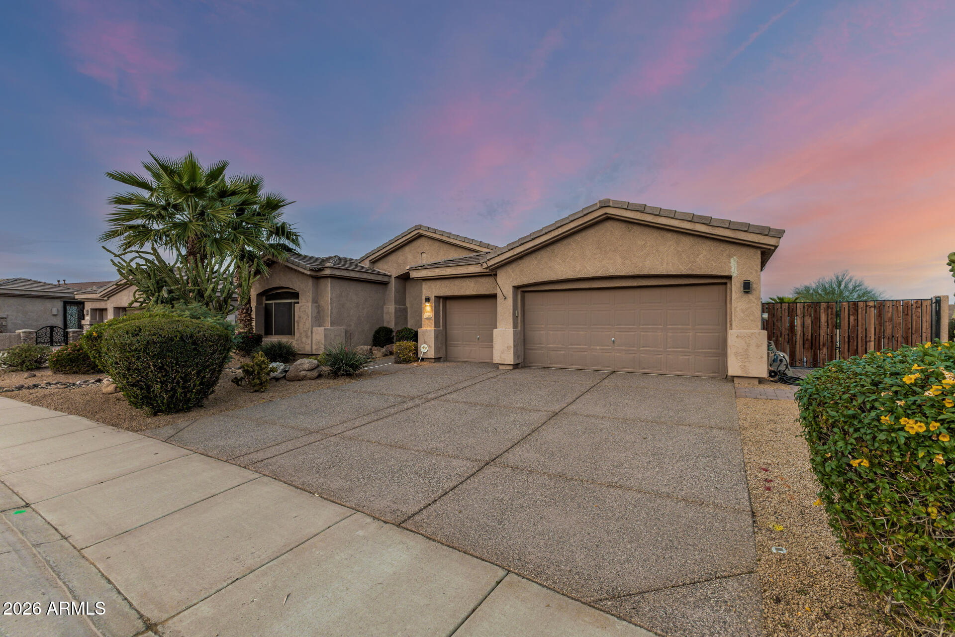 13318 West Coronado Road Goodyear, AZ 85395 - Photo 3 of 48 a front view of a house with garden