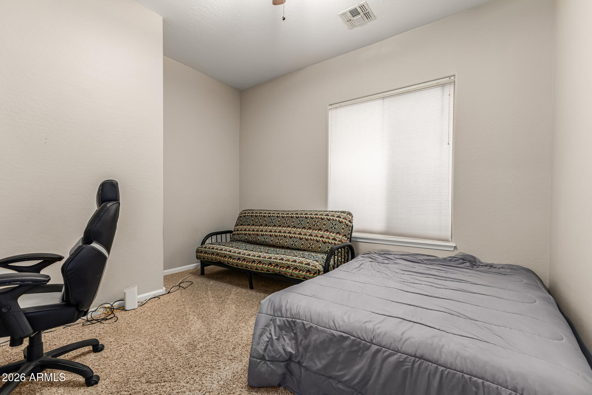13318 West Coronado Road Goodyear, AZ 85395 - Photo 32 of 48 a bedroom with a bed a desk and chair