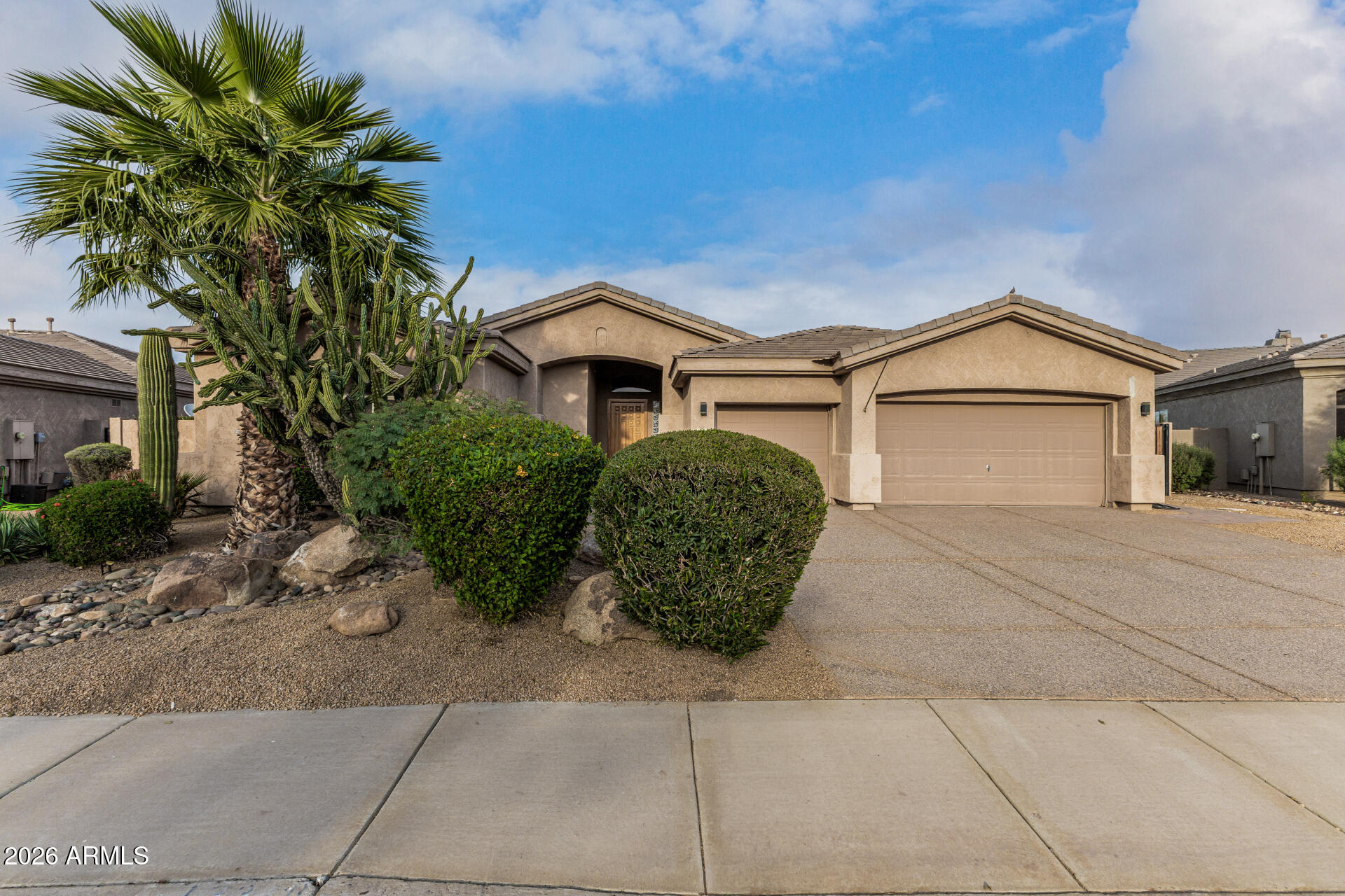 13318 West Coronado Road Goodyear, AZ 85395 - Photo 4 of 48 a front view of a house with a garden