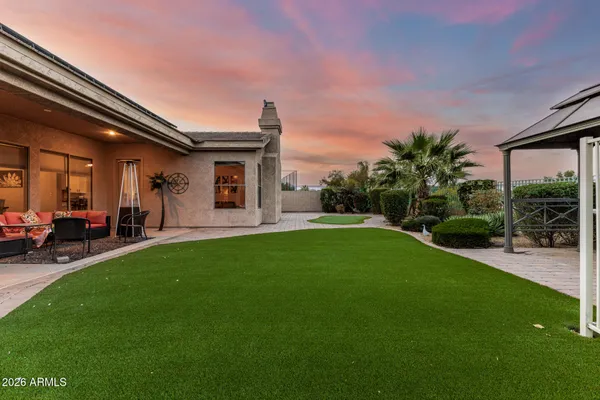 a view of a house with a backyard