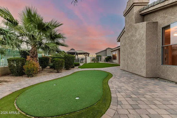 a view of a house with a backyard