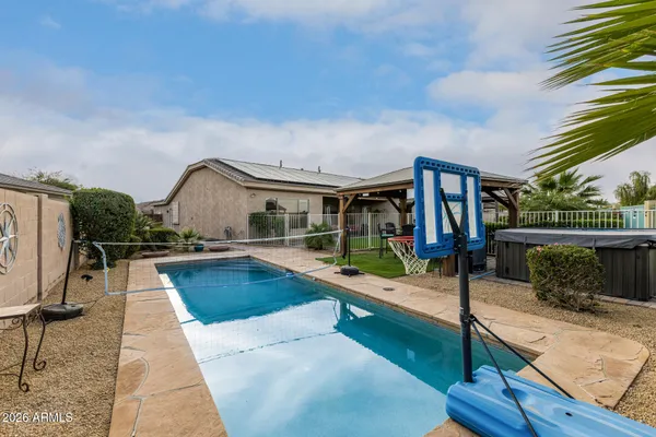 a view of a house with swimming pool and sitting area