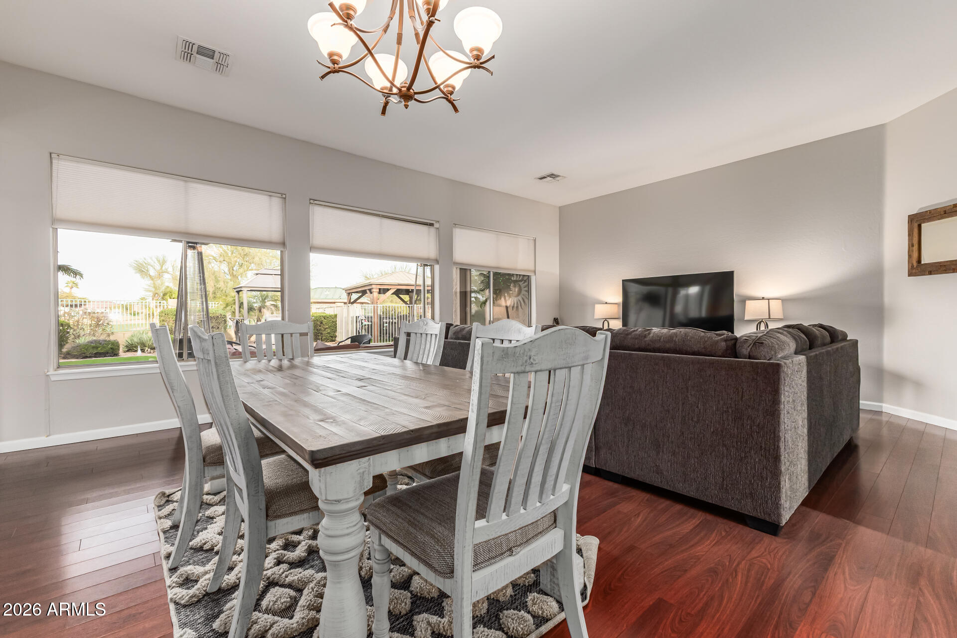 13318 West Coronado Road Goodyear, AZ 85395 - Photo 10 of 48 a view of a dining room with furniture window and wooden floor