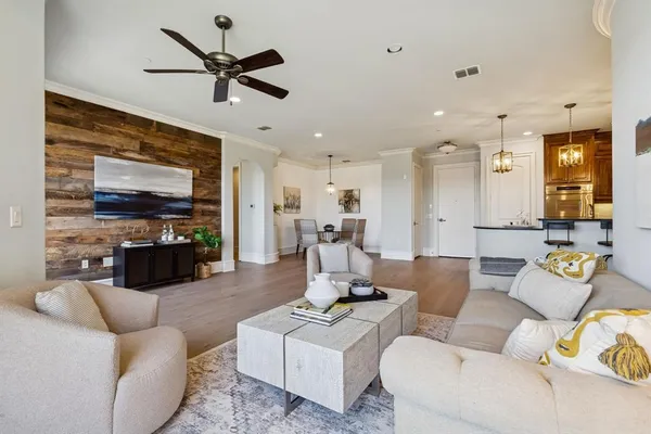 a living room with furniture and kitchen view