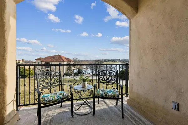 a view of a chairs and table in a balcony